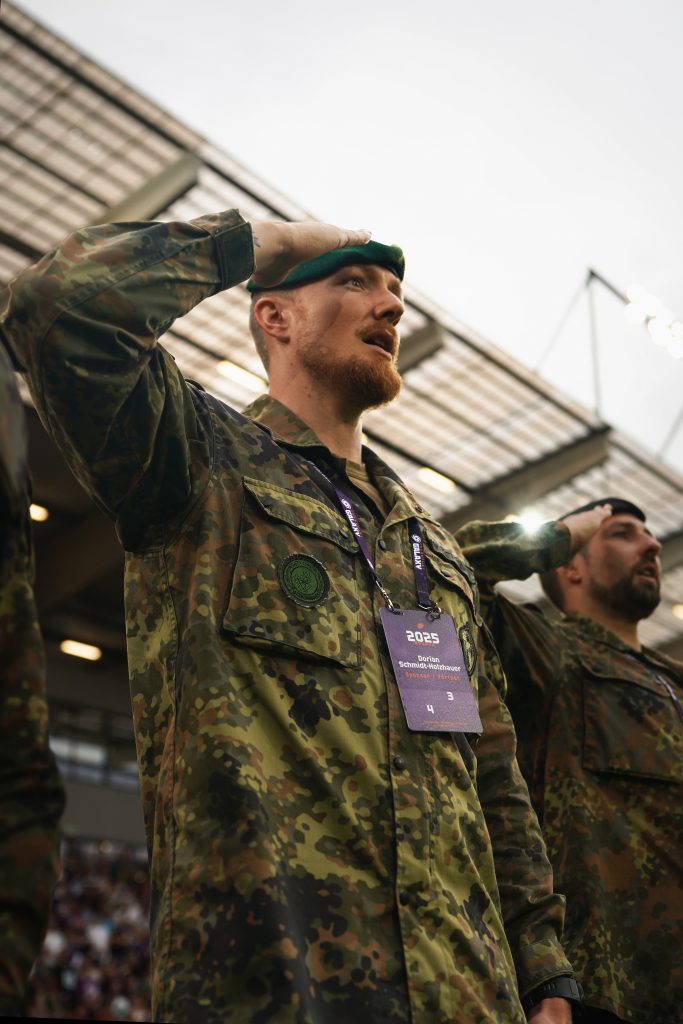 Event-Fotografie von Bundeswehr-Soldat vom KarriereCenter beim Stadion am Biederer Berg in Offenbach in der N&auml;he von Frankfurt am Main beim Salutieren vor der deutschen Nationalhymne